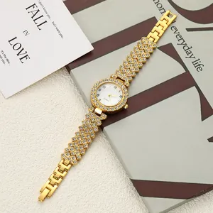 Elegant gold women's watch with rhinestone details on a lifestyle background