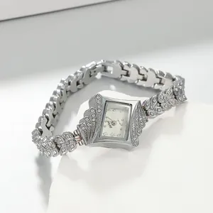 Macro view of an elegant silver rhinestone-encrusted bracelet watch with quartz movement