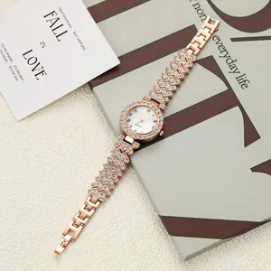 Elegant rose gold women's watch with rhinestone bracelet and white dial detail