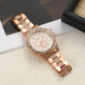 Close-up of rose gold women's watch with rhinestone pavé bezel and steel band