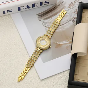 Detail view of luxury gold ladies watch with floating rhinestones and crystal bracelet.