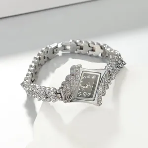 Macro detail view of an elegant silver rhinestone bracelet watch with a black dial