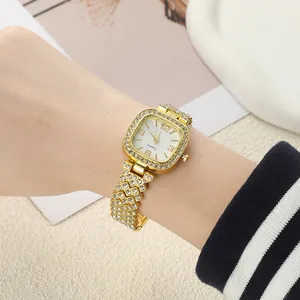 Elegant gold square quartz watch with sparkling rhinestones on a woman's wrist