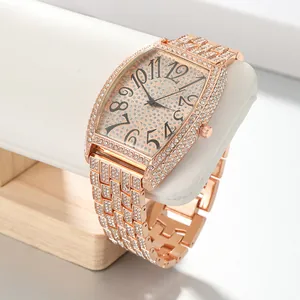 Detailed view of women's tonneau rose gold watch with full rhinestone iced out design