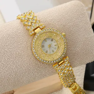 Close-up of golden women's watch with full rhinestone bezel and floating dial beads