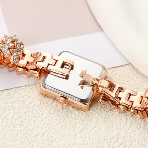 Close-up of square women's watch with rhinestone chain bracelet in rose gold finish