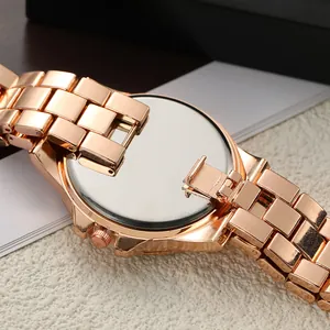 Macro view of polished rose gold watch case back and elegant link bracelet detail
