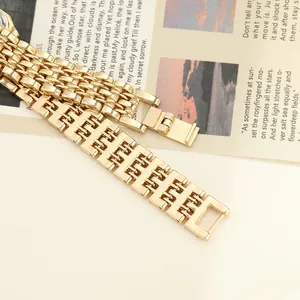 Close-up view of an elegant gold-toned link watch band with a secure folding clasp