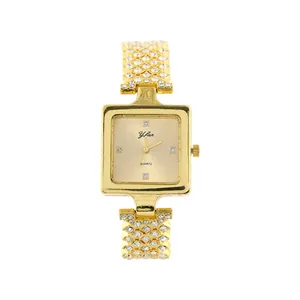 Detail of a luxury square quartz watch with a full rhinestone gold chain bracelet.