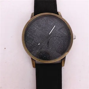 Close-up macro shot of a vintage bronze quartz watch featuring a textured blue denim pattern dial