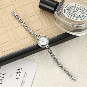 Detailed macro view of a silver ladies fashion watch with a sparkling rhinestone chain strap