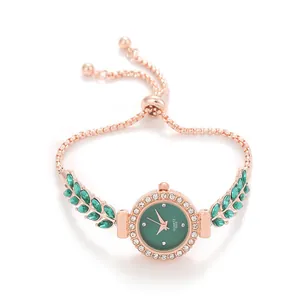 Close-up of green leaf bracelet watch with sparkling rhinestone bezel and adjustable chain