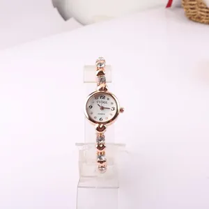 Elegant rose gold women's bracelet watch featuring crystal accents and heart links