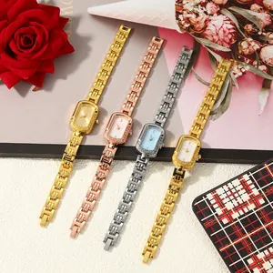 Detail view of stylish square ladies' quartz watches in gold, rose gold, and silver