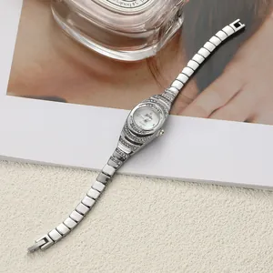 Elegant silver women's quartz bracelet watch with sparkling rhinestone detailing.
