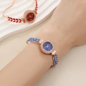 Close-up detail of a rose gold quartz bracelet watch featuring blue crystal leaf accents