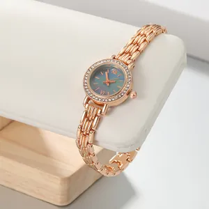Macro view of elegant rose gold women's watch with crystal bezel and slim link bracelet