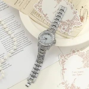 Luxury silver iced-out quartz watch for women featuring full rhinestone metal strap design