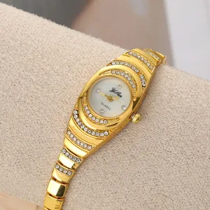 Close-up of a vintage gold women's bracelet watch with sparkling rhinestone details
