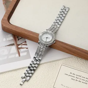 Detail of luxury silver women's watch with rhinestone bezel and link bracelet