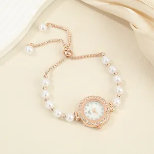 Close-up detail of luxury rose gold pearl bracelet watch with shimmering crystal dial