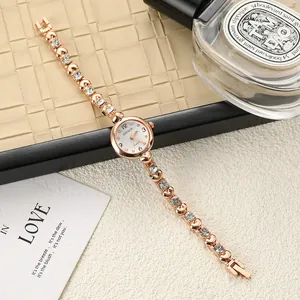 Close-up of an elegant rose gold women's bracelet watch with sparkling rhinestone details