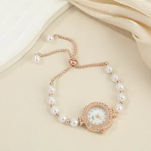Detailed view of flower-shaped rhinestone watch with elegant pearl bracelet strap