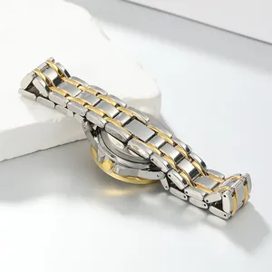 Macro view of a luxury vintage women's gold and silver stainless steel watch strap