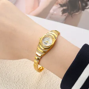 Close-up of elegant gold rhinestone bracelet watch on woman's wrist