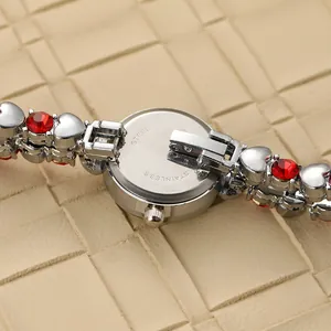 Detailed view of women's bracelet watch showing stainless steel back and red crystal hearts