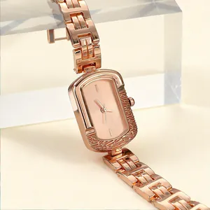 Close-up of minimalist rose gold rectangular women's quartz watch with link strap