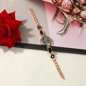 Detail of rose gold women's bracelet watch with black enamel irregular links