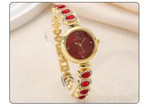 Detail macro of luxury gold bracelet watch with red stones and rhinestones and quartz