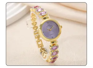 Elegant gold bracelet watch for women featuring purple gemstones and sparkling rhinestones