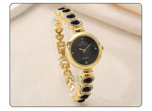Elegant gold-tone luxury women's bracelet watch featuring a black dial and sparkling crystal accents