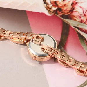 Close-up view of the rose gold chain bracelet and back case of a women's quartz watch