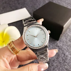 Detailed view of silver ladies watch with blue dial and rhinestone bezel