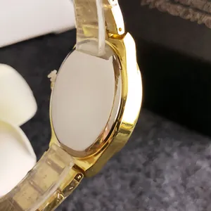 Detailed macro view of the gold-toned watch case back and polished side profile