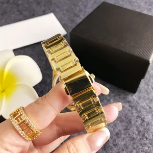 Detailed view of the polished gold-tone metal link strap of a women's watch