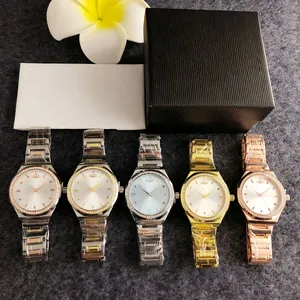 Set of elegant ladies' watches with crystal-set bezels and diverse metal finishes in gift box.