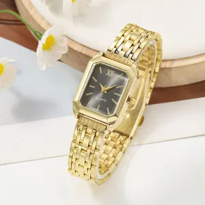 Close-up of elegant rectangular quartz watch for women with a gold steel link bracelet