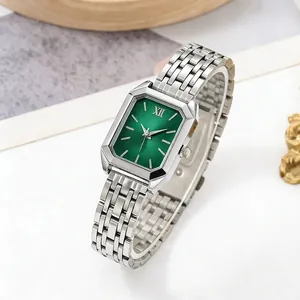 Macro detail of elegant rectangular women's quartz watch with green dial and silver steel strap