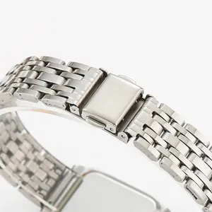 Detail of a silver stainless steel women's watch strap with a secure folding clasp.