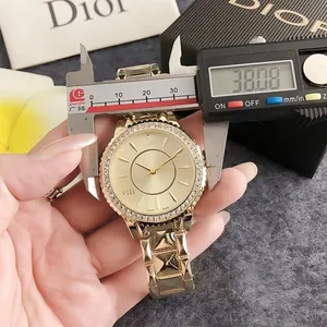 Detail shot of a vintage gold-toned women's watch with a 38.08mm measurement on a digital caliper.