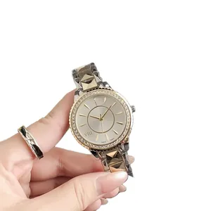 Elegant vintage women's watch with crystal-encrusted bezel and gold-tone metal strap