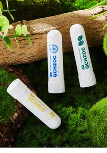 Set of three aromatic essential oil nasal inhalers for energy boost on green moss
