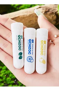 Three refreshing essential oil nasal inhaler sticks with mint flavor in a hand close-up shot.