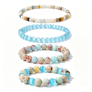 Macro detail of a 4-piece healing crystal beaded bracelet set in blue and earth tones