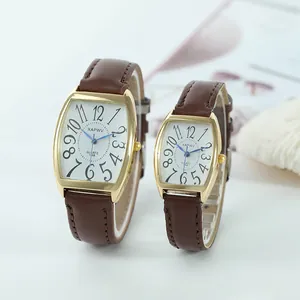 Pair of tonneau-shaped quartz watches with brown leather straps and gold cases