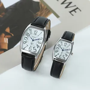 Close-up of XAPWV tonneau-shaped couple watches with black leather straps